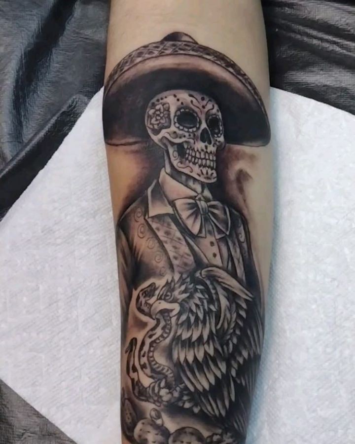 Featured black and grey tattoo by Ryan Karagory — charro skeleton with sombrero on a forearm